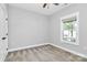 Cozy bedroom features neutral walls, plush carpeting, and a window offering natural light at 323 Keswick Ave, Charlotte, NC 28206