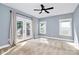 Bright bedroom with French doors opening to a deck and featuring neutral walls and carpet at 323 Keswick Ave, Charlotte, NC 28206