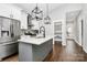 Modern kitchen boasts stainless steel appliances, a kitchen island with a sink, and pendant lighting at 323 Keswick Ave, Charlotte, NC 28206