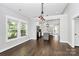 Hardwood floors open to kitchen with island, stainless steel appliances, and bright natural light at 323 Keswick Ave, Charlotte, NC 28206