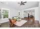 Bright living room with hardwood floors, neutral walls, and open layout to the kitchen at 323 Keswick Ave, Charlotte, NC 28206
