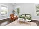 Cozy living room featuring hardwood floors, two windows and comfortable seating and area rug at 323 Keswick Ave, Charlotte, NC 28206