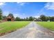 Picturesque view of a well-maintained property with a charming red barn, expansive green lawn, and inviting main house at 3451 Greene Rd, Monroe, NC 28110