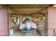 Inside a barn featuring a boat under a beige cover, with wooden beams and supports above at 3451 Greene Rd, Monroe, NC 28110