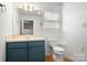 Clean bathroom with vanity, mirror, and toilet, featuring a window for natural light at 3451 Greene Rd, Monroe, NC 28110
