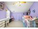 Spacious bedroom featuring purple walls, sloped ceilings, white trim, and a large window at 3451 Greene Rd, Monroe, NC 28110