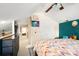 Bright bedroom with a view of the landing, a double door closet, colorful bedspread, and teal accent wall at 3451 Greene Rd, Monroe, NC 28110