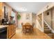 Cozy dining area with wooden table and chairs, leading to the staircase at 3451 Greene Rd, Monroe, NC 28110