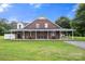 Charming brick home with a spacious front porch, perfect for enjoying the outdoors at 3451 Greene Rd, Monroe, NC 28110