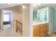 Hallway and the bathroom with double sinks, beach themed decor and light wood cabinets at 3451 Greene Rd, Monroe, NC 28110