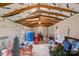 Spacious garage or storage area with wood beams, ample storage containers, and potential for customization at 3451 Greene Rd, Monroe, NC 28110