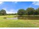 Picturesque pond surrounded by lush greenery, creating a serene and private setting at 3451 Greene Rd, Monroe, NC 28110