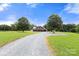 Charming home with a long driveway, mature trees, and a welcoming front porch, set on a spacious lot at 3451 Greene Rd, Monroe, NC 28110