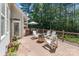 Relaxing backyard deck with a fire pit, grill, and ample seating surrounded by lush trees at 347 Bayberry Creek Cir, Mooresville, NC 28117