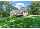 Well-maintained backyard with green lawn, spacious deck, and mature trees creating a serene outdoor space at 347 Bayberry Creek Cir, Mooresville, NC 28117