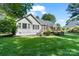 Spacious backyard with a well-manicured lawn, mature trees, and a large deck for outdoor entertaining at 347 Bayberry Creek Cir, Mooresville, NC 28117