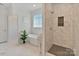 Bathroom showcasing a tub under a window and a tiled shower with built-in shelves at 347 Bayberry Creek Cir, Mooresville, NC 28117