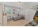 bedroom featuring two windows, a single bed, and a desk with a chair at 347 Bayberry Creek Cir, Mooresville, NC 28117