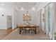 Bright dining room with wooden table, modern decor, and a decorative chandelier at 347 Bayberry Creek Cir, Mooresville, NC 28117