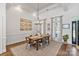 Elegant dining room with wooden table, stylish chairs, decorative lighting, and large windows at 347 Bayberry Creek Cir, Mooresville, NC 28117