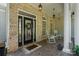 Inviting front porch with brick facade, decorative door, and charming rocking chairs at 347 Bayberry Creek Cir, Mooresville, NC 28117