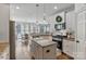Bright kitchen features stainless steel appliances, white cabinetry, granite countertops, and hardwood floors at 347 Bayberry Creek Cir, Mooresville, NC 28117