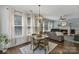 Inviting living room with a fireplace, hardwood floors, large windows, and a modern light fixture at 347 Bayberry Creek Cir, Mooresville, NC 28117