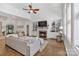 Bright living room features a fireplace with built-in shelving, ceiling fan, and hardwood floors at 347 Bayberry Creek Cir, Mooresville, NC 28117