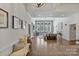 Spacious living room with fireplace, hardwood floors, large windows, and modern decor at 347 Bayberry Creek Cir, Mooresville, NC 28117