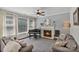 Living room with fireplace, piano, large windows, and comfortable seating area at 347 Bayberry Creek Cir, Mooresville, NC 28117