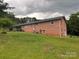 Brick home with a large backyard and carport featuring mature trees and an air conditioning unit outside at 356 Lucky Hollow Rd, Hickory, NC 28601