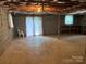 Unfinished basement with exposed ceilings, concrete flooring, and walk-out doors at 356 Lucky Hollow Rd, Hickory, NC 28601
