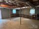 Unfinished basement featuring exposed ceiling, shelving, and concrete flooring at 356 Lucky Hollow Rd, Hickory, NC 28601