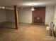 Unfinished basement features concrete floor, exposed beams, and a brick fireplace at 356 Lucky Hollow Rd, Hickory, NC 28601