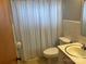 This full bath showcases a blue and white striped shower curtain and neutral tile at 356 Lucky Hollow Rd, Hickory, NC 28601