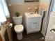Tiled bathroom features a single sink vanity and toilet, creating a functional space at 356 Lucky Hollow Rd, Hickory, NC 28601