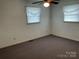 Bedroom features carpeted floors, ceiling fan, and natural light from two windows at 356 Lucky Hollow Rd, Hickory, NC 28601