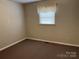 Bedroom showcases neutral walls, carpet flooring, and a window for natural light at 356 Lucky Hollow Rd, Hickory, NC 28601