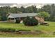 Brick home with carport and a partially landscaped yard featuring several green bushes and a stone-lined firepit at 356 Lucky Hollow Rd, Hickory, NC 28601
