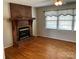 Cozy living room featuring a brick fireplace and hardwood floors at 356 Lucky Hollow Rd, Hickory, NC 28601