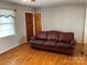 Living room featuring hardwood floors, sofa, and natural light from a window at 356 Lucky Hollow Rd, Hickory, NC 28601