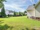 Expansive backyard with manicured lawn, mature trees, and residential views, providing a serene outdoor space at 3697 Travertine Dr, Lancaster, SC 29720