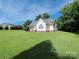 Wide backyard with healthy green grass and mature trees surrounding the property, providing a private retreat at 3697 Travertine Dr, Lancaster, SC 29720