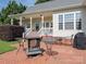 Charming backyard patio with brick pavers, seating, and fire pit, perfect for outdoor gatherings at 3697 Travertine Dr, Lancaster, SC 29720