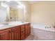 This bathroom boasts a double sink vanity, garden tub, and tile flooring at 3697 Travertine Dr, Lancaster, SC 29720