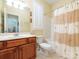Neat bathroom with vanity, toilet and shower-tub combo featuring a tropical shower curtain at 3697 Travertine Dr, Lancaster, SC 29720
