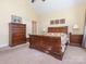 This bedroom features warm-toned walls, a wood sleigh bed, and a matching dresser at 3697 Travertine Dr, Lancaster, SC 29720