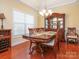 Elegant dining room with hardwood floors, stylish chandelier, and a classic china cabinet at 3697 Travertine Dr, Lancaster, SC 29720