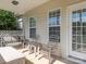 Inviting covered front porch with seating and natural light creating a warm welcome to the home at 3697 Travertine Dr, Lancaster, SC 29720