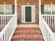 Charming front porch with brick stairs and white railings, great for relaxing outdoors at 3697 Travertine Dr, Lancaster, SC 29720